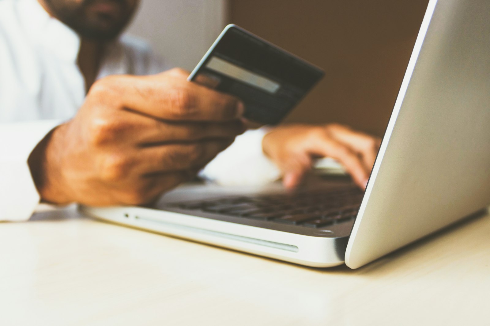Paying a bill online with a card and laptop